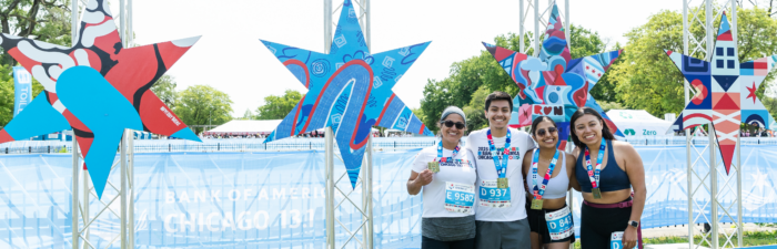 Finishers posing with Chicago star display after the 2025 Bank of America Chicago 13.1
